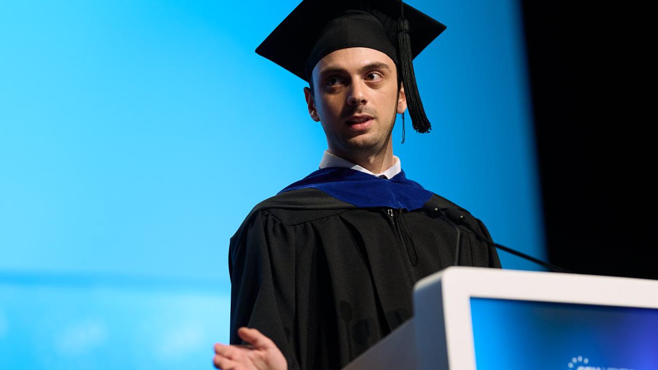 CEU graduating speaker wearing gown making his speech at lecturer 